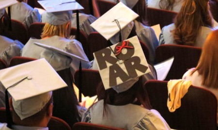Graduate wearing grad cap that says ROAR