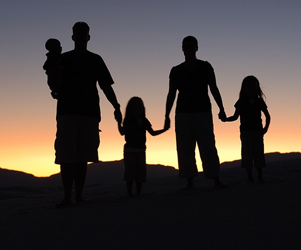 A family--two adults and three children--silhouetted against a setting sun by  Luis Armando Rasteletti https://creativecommons.org/licenses/by-sa/2.0/deed.en