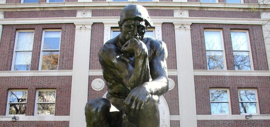 Statue on campus of man thinking