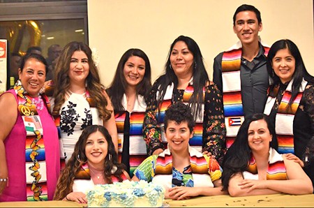 Multiple latinx members gather for a group photo