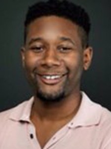 James C. Sampson, Jr. James wears a smile and a champagne colored button down shirt.