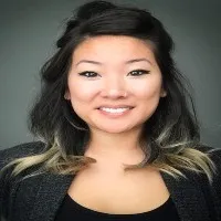Alison Chou wears a dark top she smiles straight on into camera 