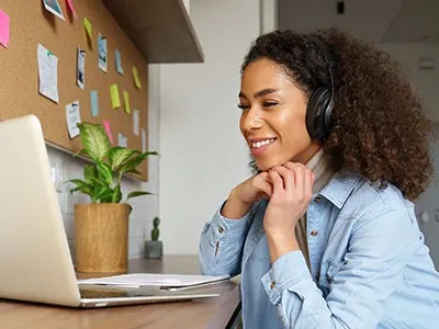 Woman attending online class via her laptop.