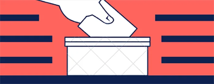 A hand drops a ballot into a ballot box