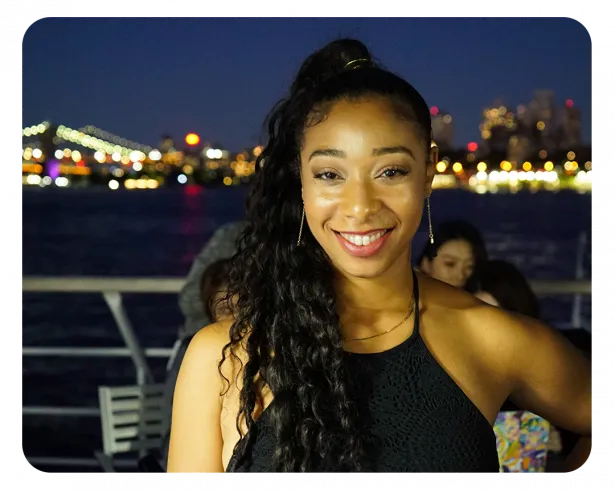 Krysal smiles into camera wearing a black top and pony tailed hair