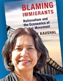 Neeraj Kaushal smiles in front of book cover wearing a greyish colored sweater.